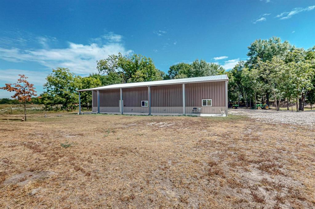 637 Lyman T Davis Road Corsicana, TX 75110 - Photo 26 of 34 a backyard of a house with plants and trees