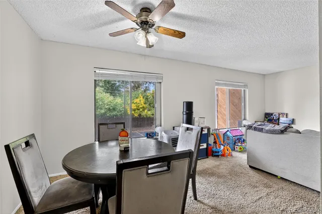 a view of a dining room with furniture window and outside view