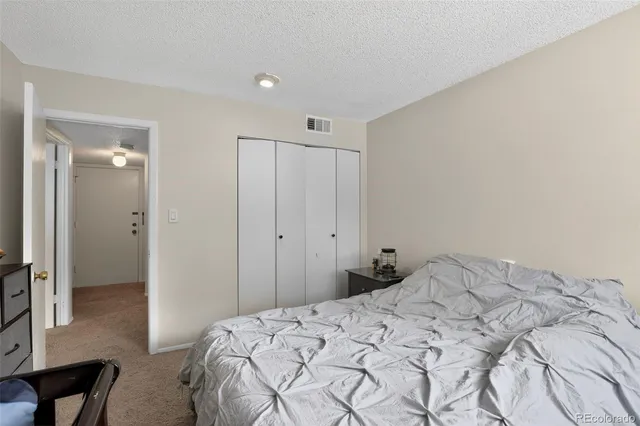 a bedroom with a bed and a table in it