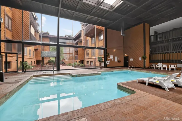 a swimming pool view with a outdoor seating