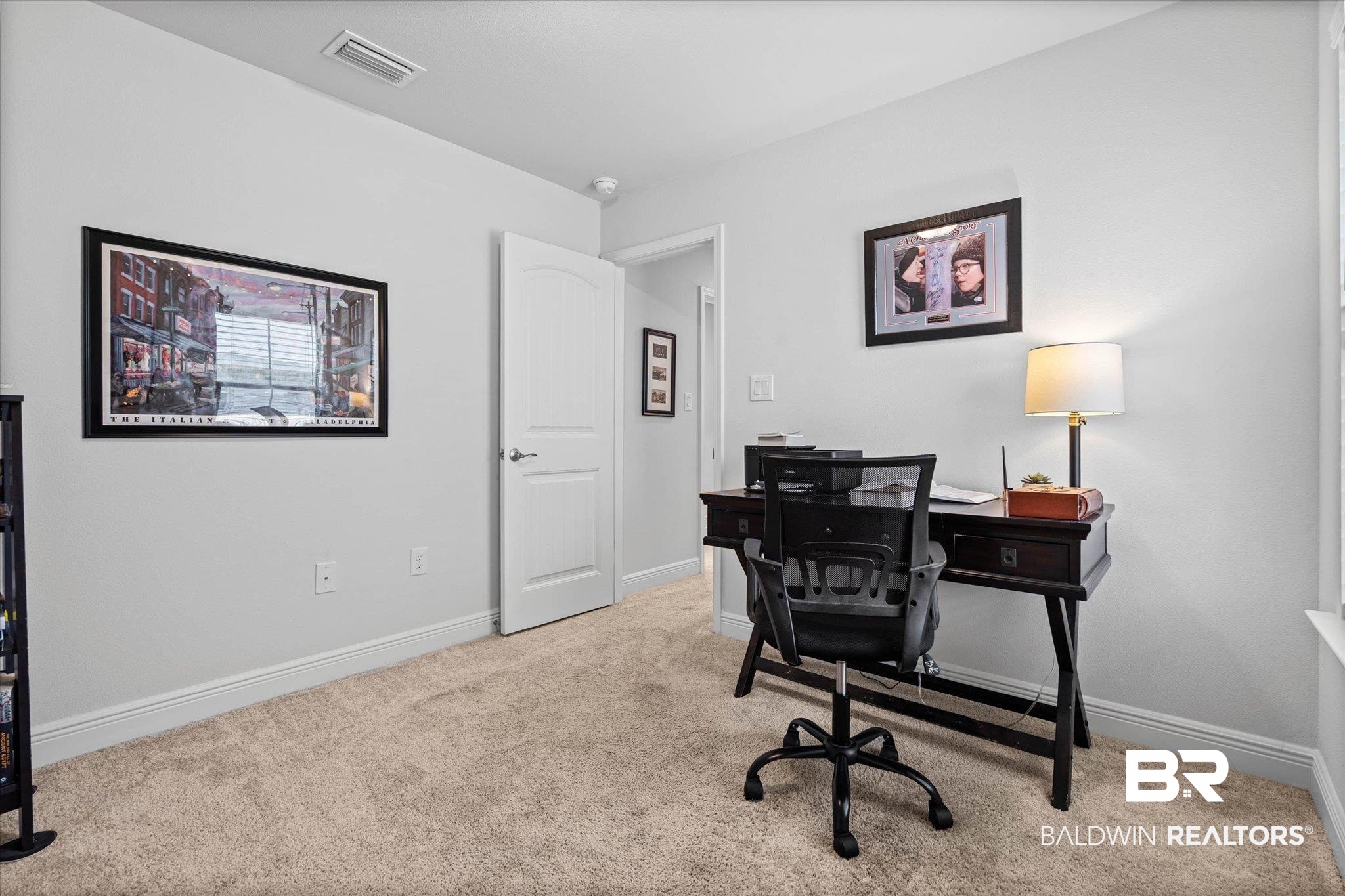22420 Respite Lane Foley, AL 36535 - Photo 15 of 35 Carpeted room with light neutral wall paint, white trim, and a white arched interior door