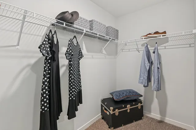 a view of walk in closet with clothes