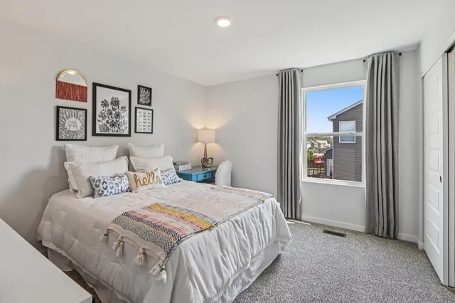 a bedroom with a bed and a window