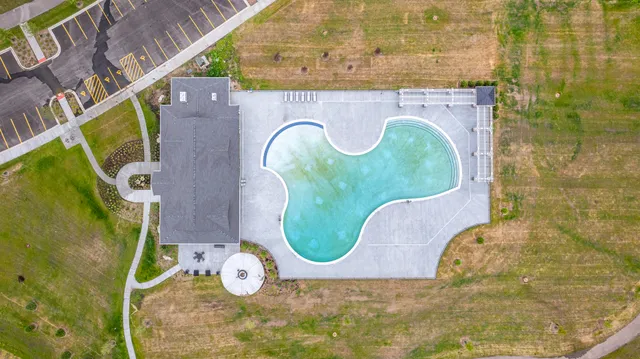 an aerial view of a house with a swimming pool