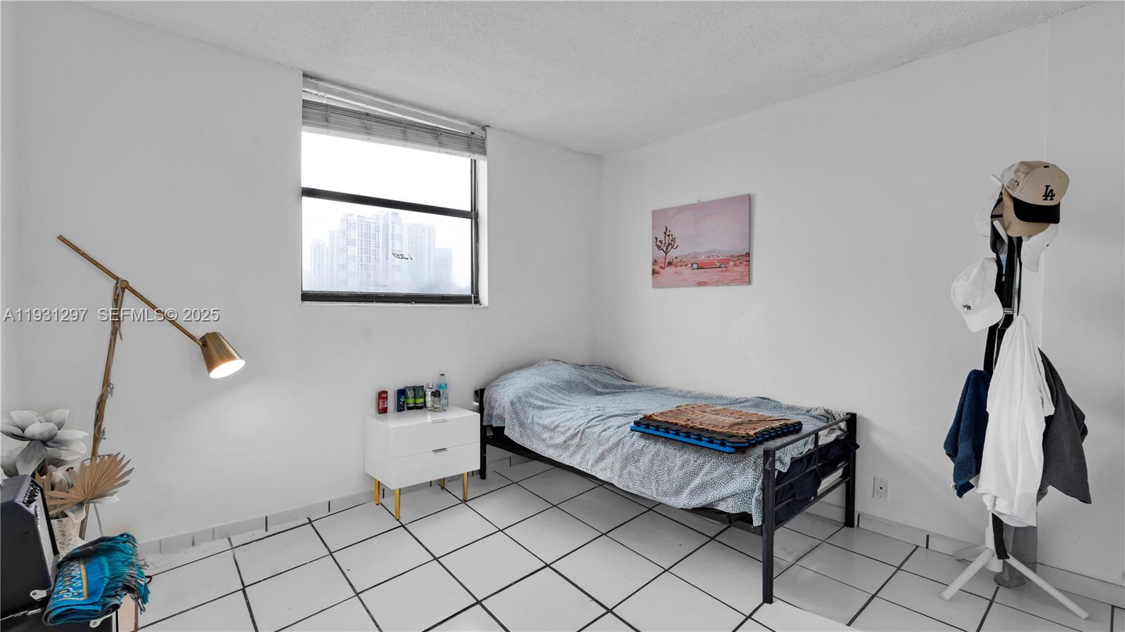 546 Southwest 1st Street, Unit 603 Miami, FL 33130 - Photo 11 of 14 a bedroom with a bed and a window