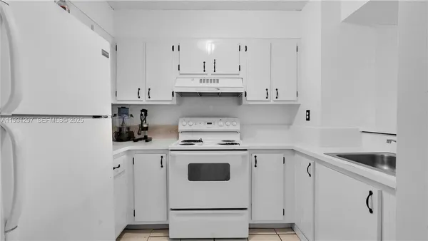 a kitchen with cabinets appliances and a sink
