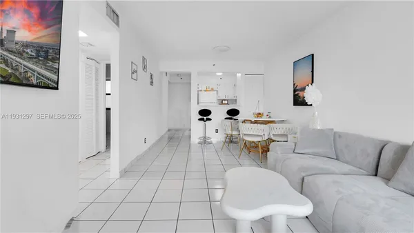 a living room with furniture and a large mirror