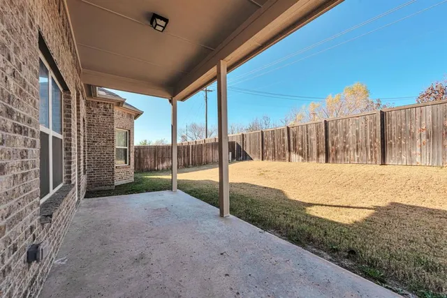 a front view of a house with a yard covered with snow in front of house