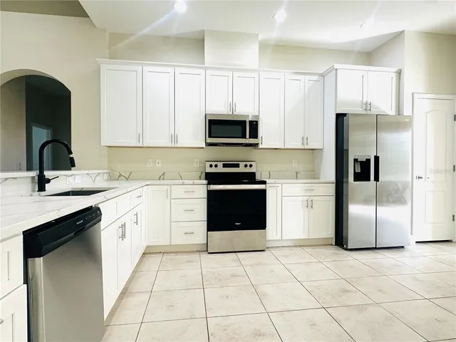 a kitchen with a sink a stove and refrigerator