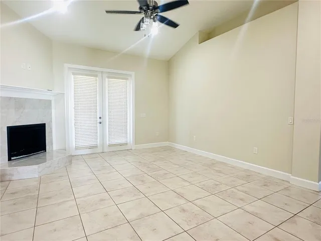 a view of an empty room with a fireplace