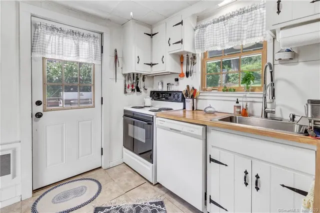 a kitchen with appliances cabinets and a sink