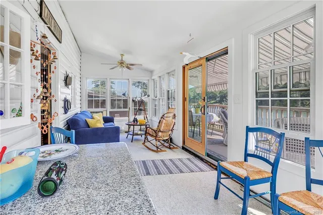 a living room with furniture and a floor to ceiling window