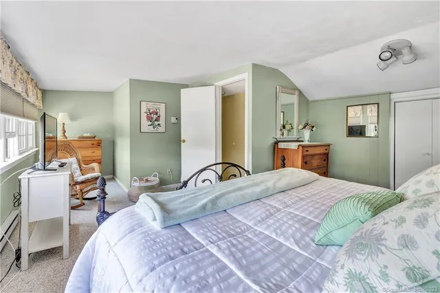 a bedroom with a bed and dresser