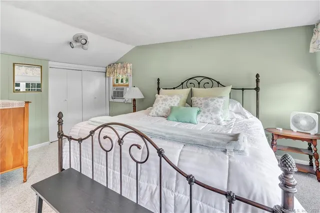 a bedroom with a bed and chair