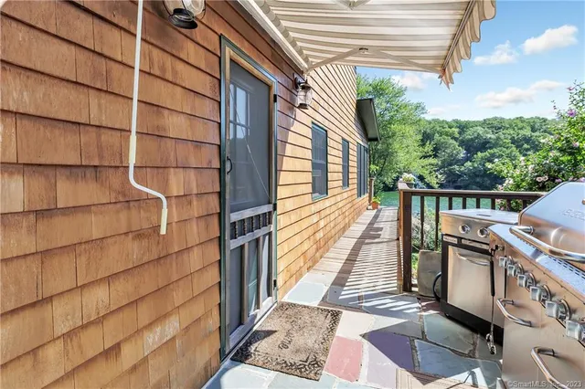 a balcony with view of wooden floor and a large window
