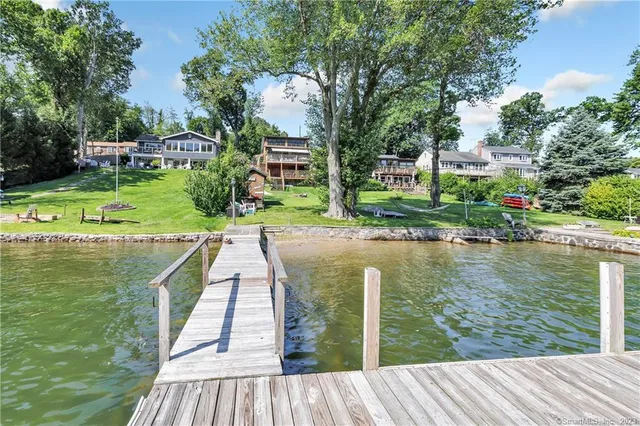 a view of a lake with a wooden deck