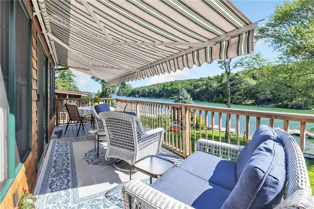 a view of a chair and tables in the balcony