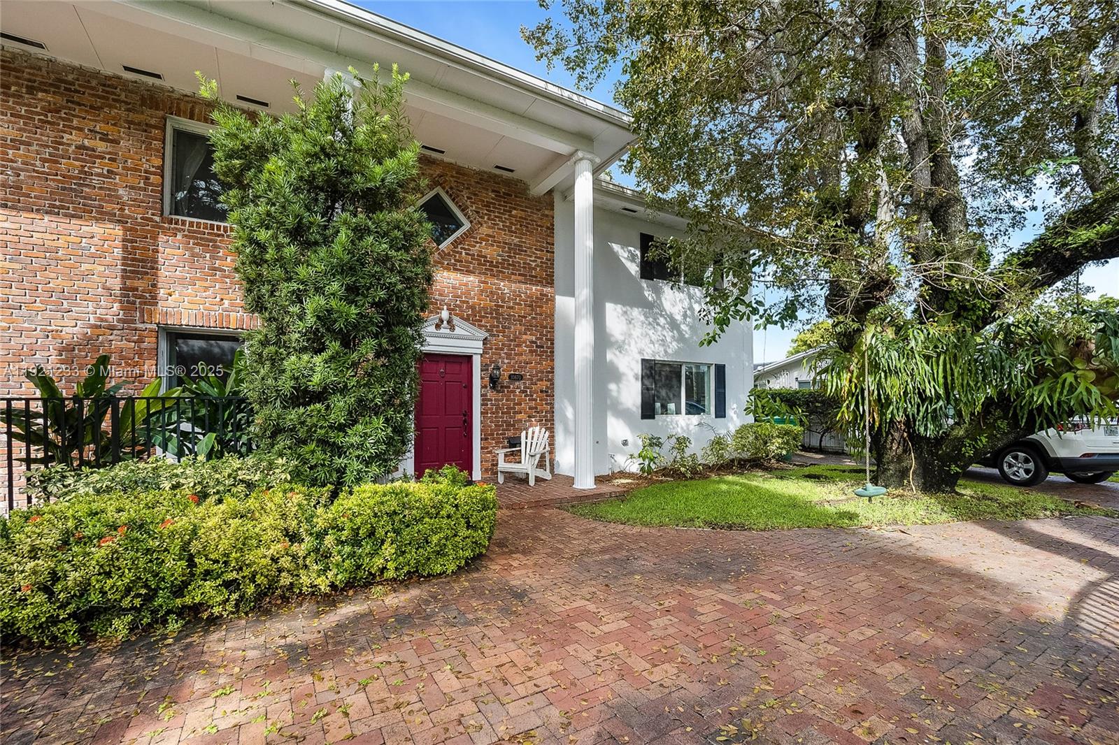 a front view of a house with a yard and shrubs