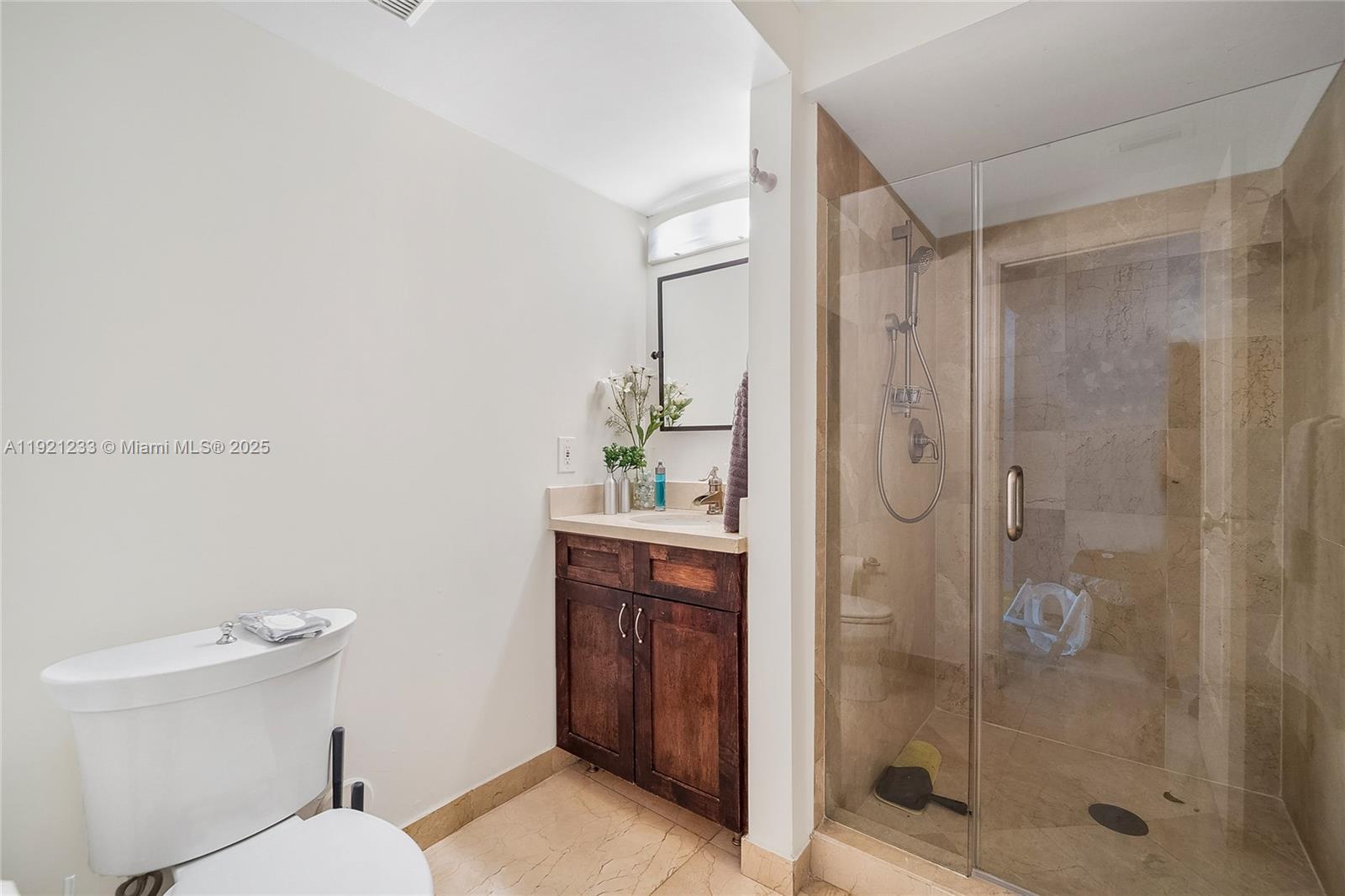 10670 Southwest 77th Avenue, Unit 10670 Pinecrest, FL 33156 - Photo 13 of 28 a bathroom with a shower a toilet and sink