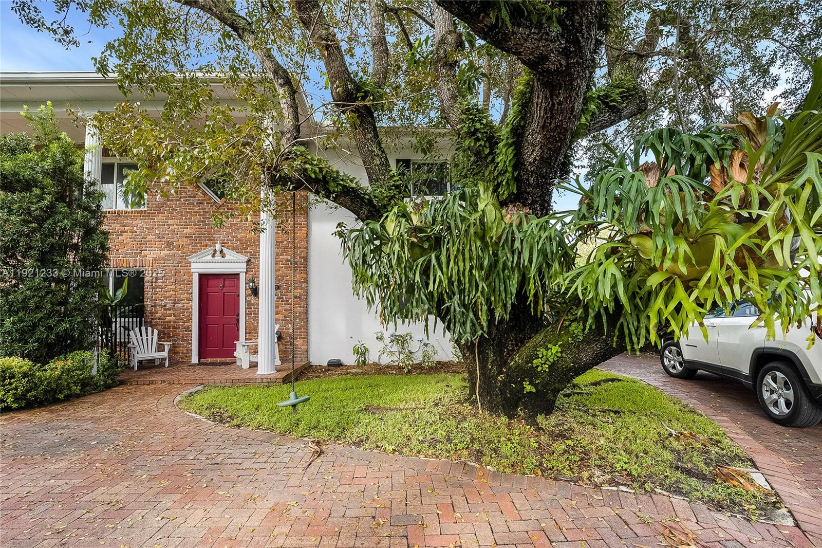 10670 Southwest 77th Avenue, Unit 10670 Pinecrest, FL 33156 - Photo 2 of 28 a front view of a house with a yard