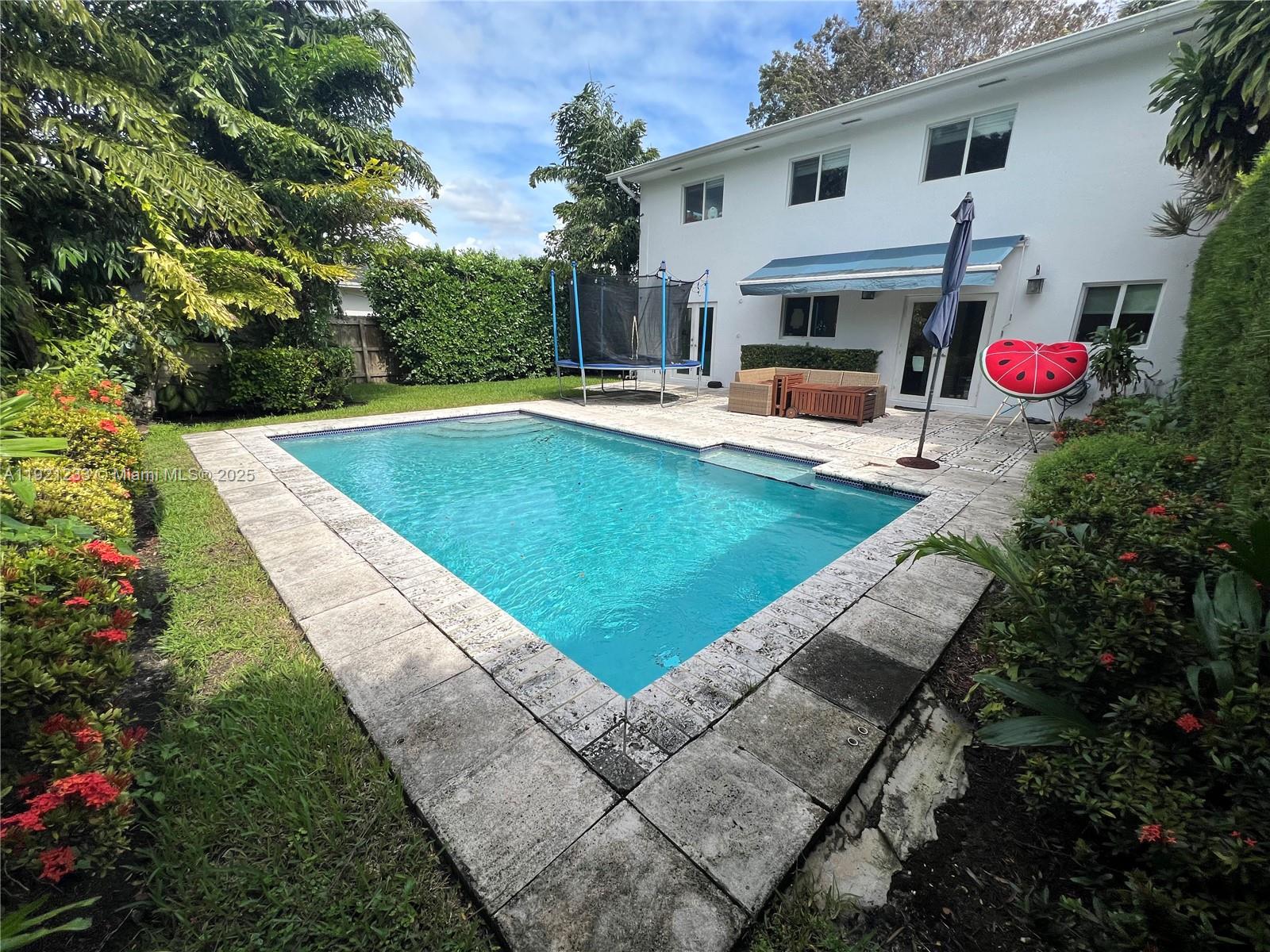10670 Southwest 77th Avenue, Unit 10670 Pinecrest, FL 33156 - Photo 24 of 28 a view of outdoor space yard swimming pool and furniture