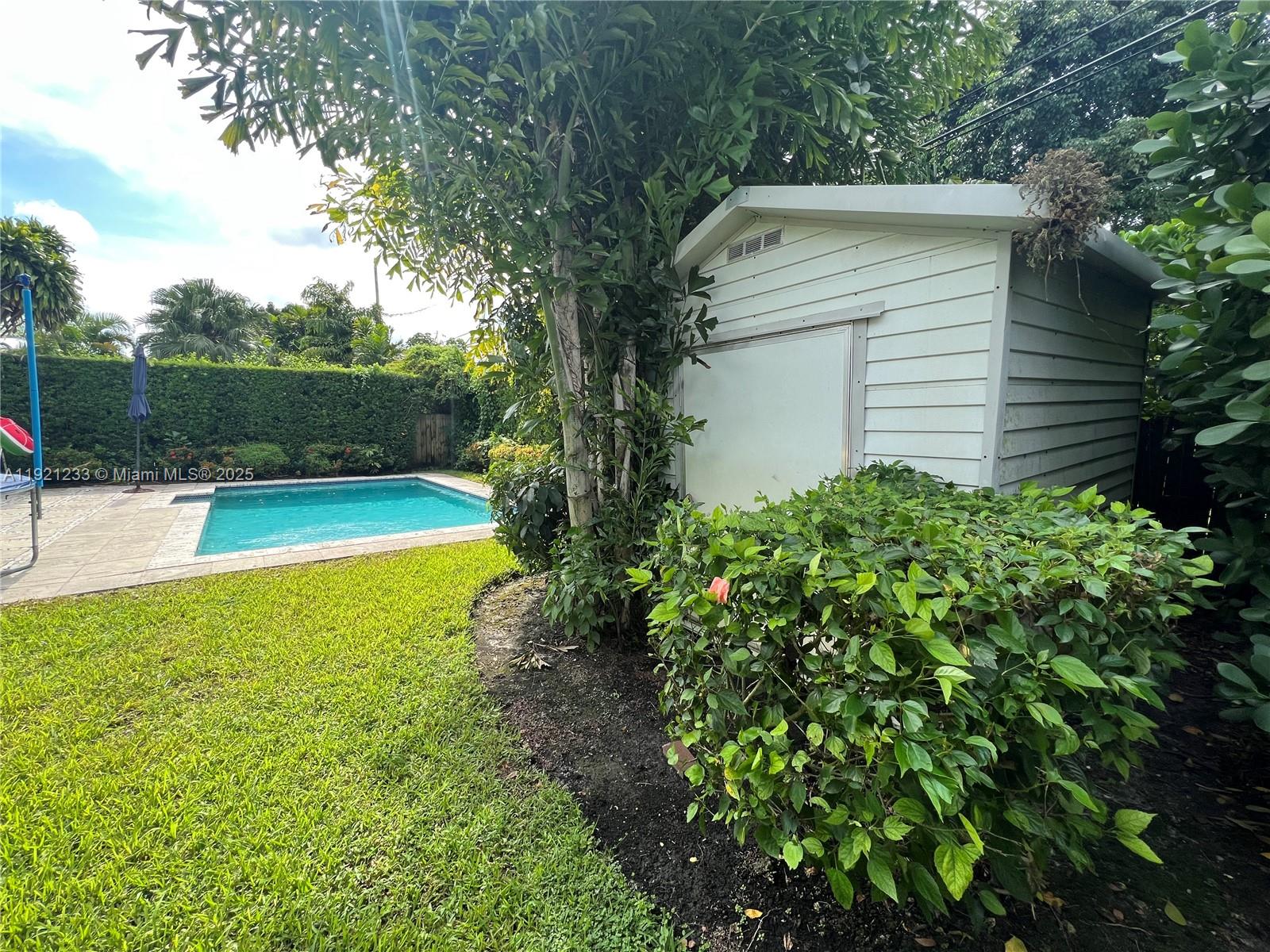 10670 Southwest 77th Avenue, Unit 10670 Pinecrest, FL 33156 - Photo 28 of 28 a view of a backyard with swimming pool
