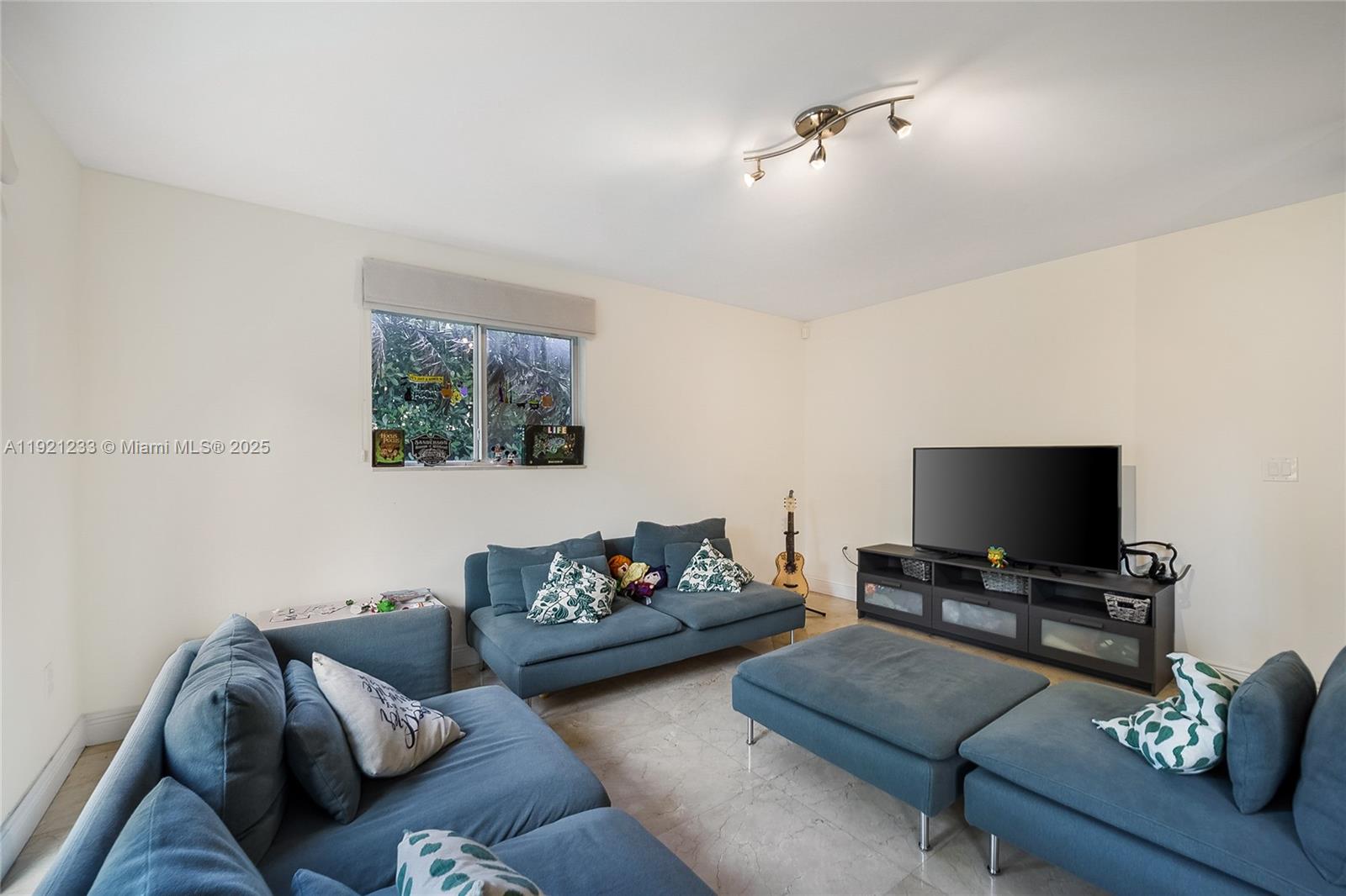 10670 Southwest 77th Avenue, Unit 10670 Pinecrest, FL 33156 - Photo 6 of 28 a living room with furniture and a flat screen tv