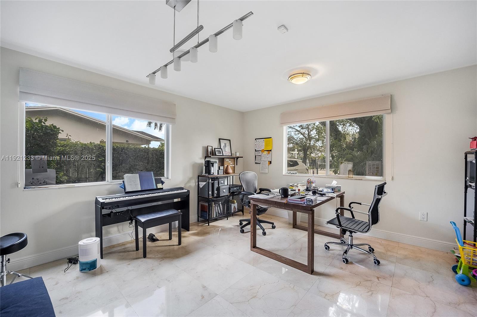 10670 Southwest 77th Avenue, Unit 10670 Pinecrest, FL 33156 - Photo 9 of 28 a view of a workspace with furniture and a window