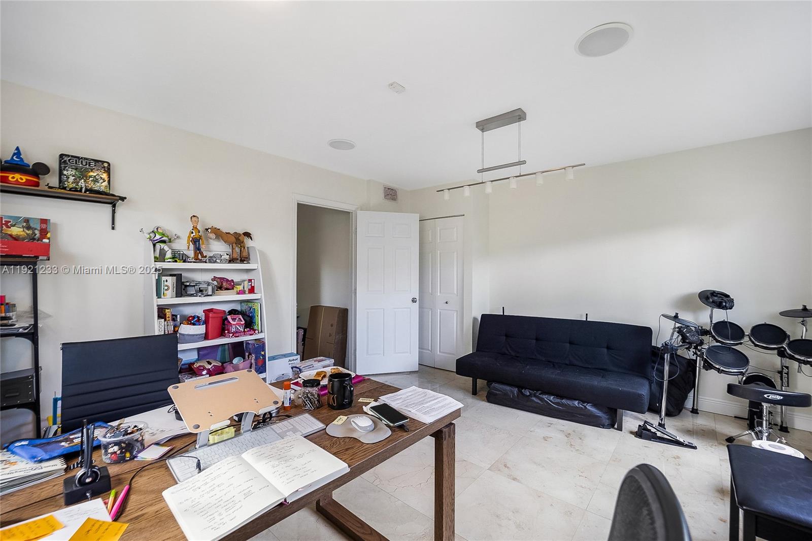 10670 Southwest 77th Avenue, Unit 10670 Pinecrest, FL 33156 - Photo 10 of 28 a room with furniture and musical instruments