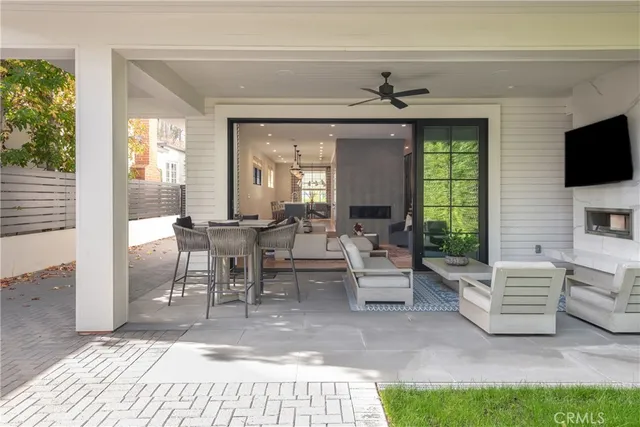 a living room with couches and a potted plant