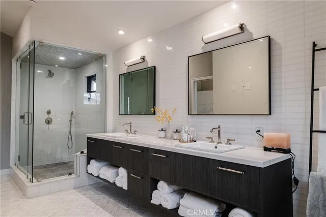 a bathroom with a tub double sink and mirror