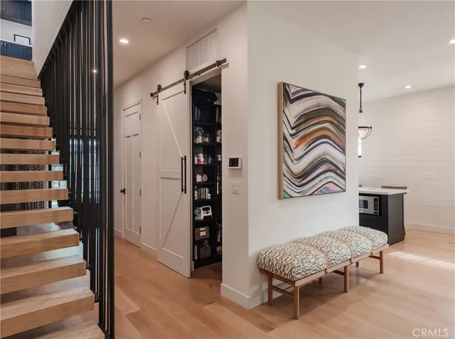 a kitchen with a dining table chairs stainless steel appliances and cabinets