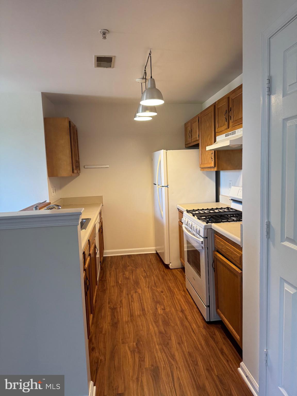 1210 Perry Street Northeast, Unit 202 Washington, DC 20017 - Photo 13 of 30 a kitchen with a refrigerator and a stove top oven