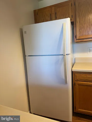 a white refrigerator freezer sitting in a kitchen