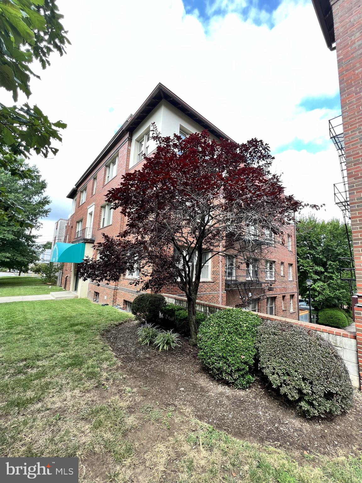 1210 Perry Street Northeast, Unit 202 Washington, DC 20017 - Photo 2 of 30 a front view of a house with a yard