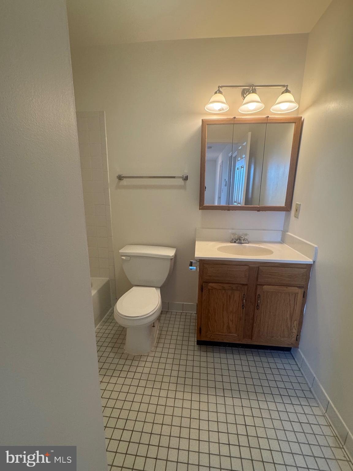 1210 Perry Street Northeast, Unit 202 Washington, DC 20017 - Photo 23 of 30 a bathroom with a toilet a sink and mirror