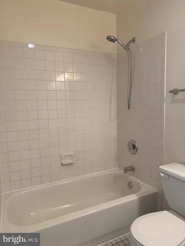 a white bath tub sitting next to a white toilet and a sink