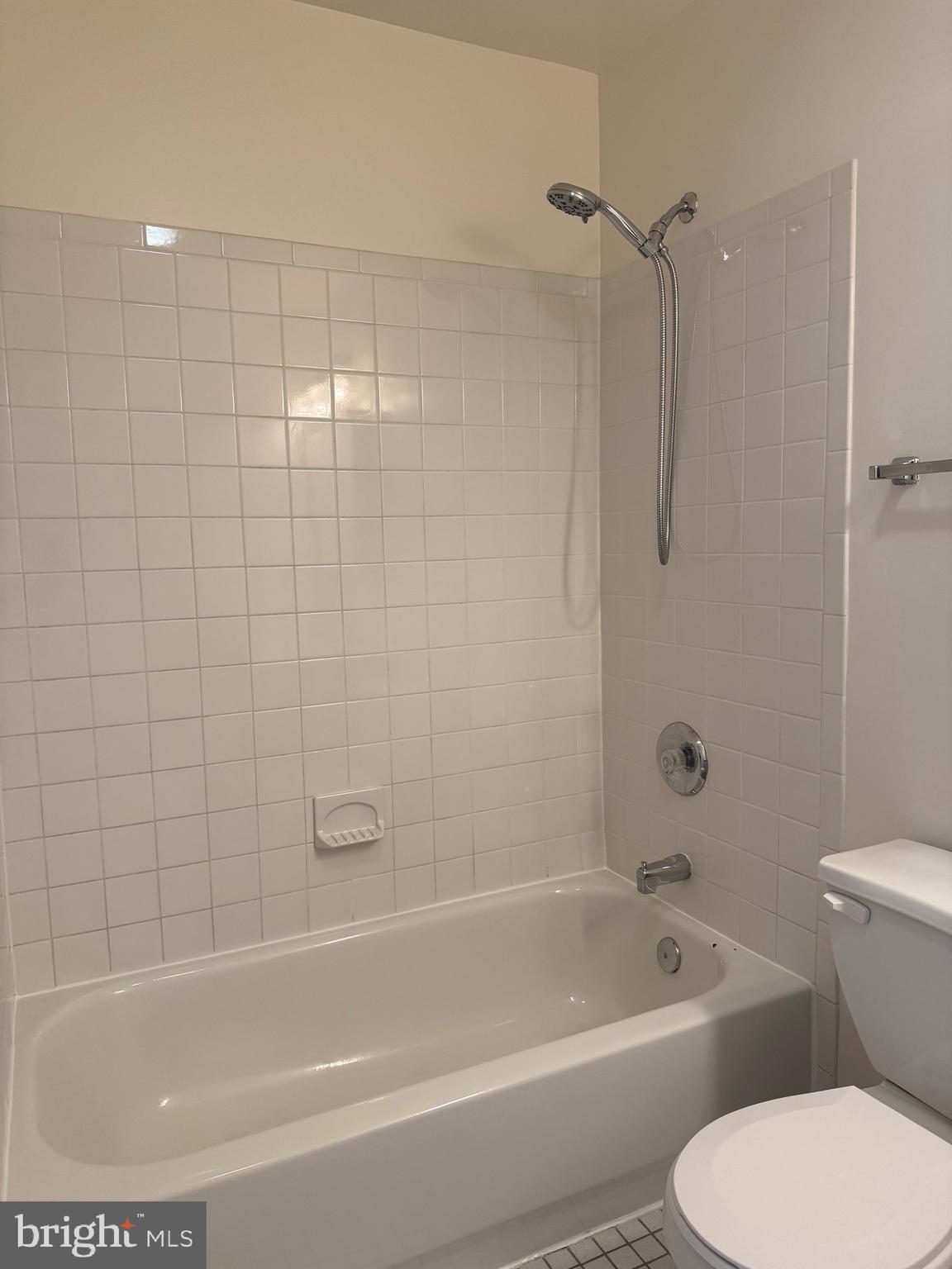 1210 Perry Street Northeast, Unit 202 Washington, DC 20017 - Photo 25 of 30 a white bath tub sitting next to a white toilet and a sink