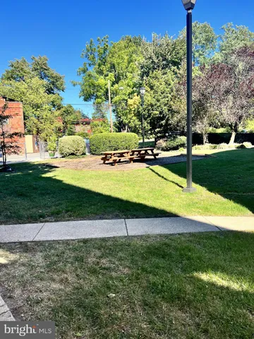 a swimming pool with lots of green space