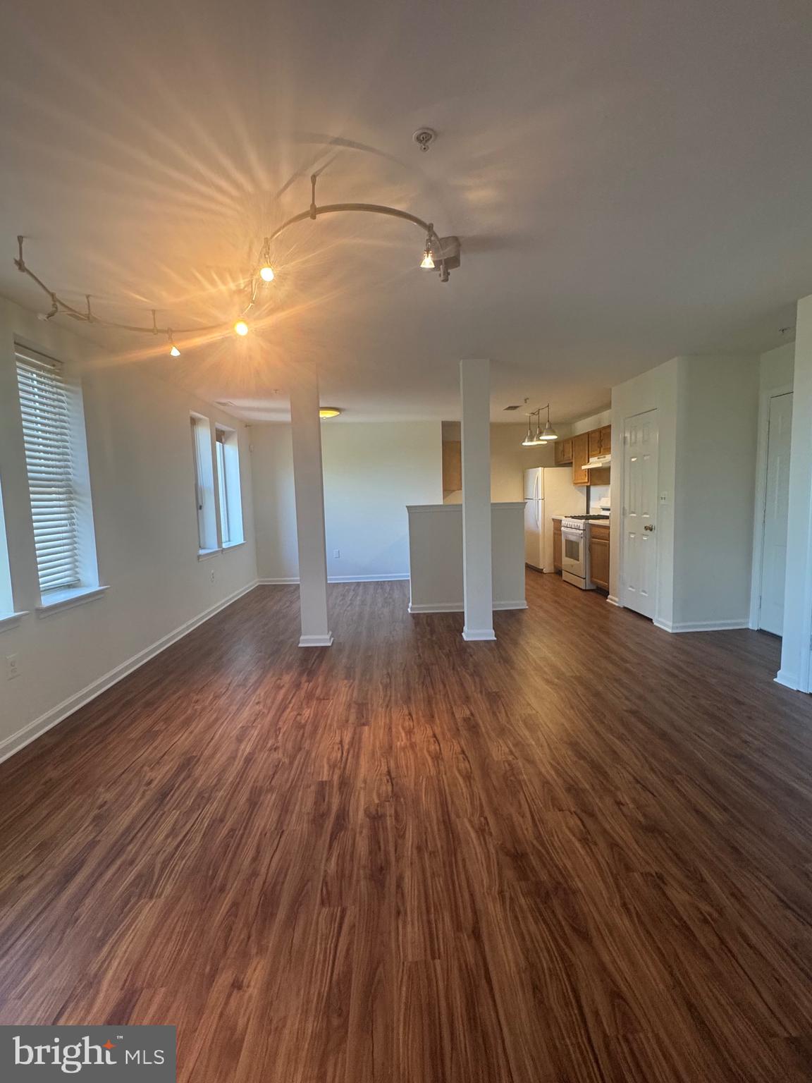 1210 Perry Street Northeast, Unit 202 Washington, DC 20017 - Photo 10 of 30 a view of a room with wooden floor and window
