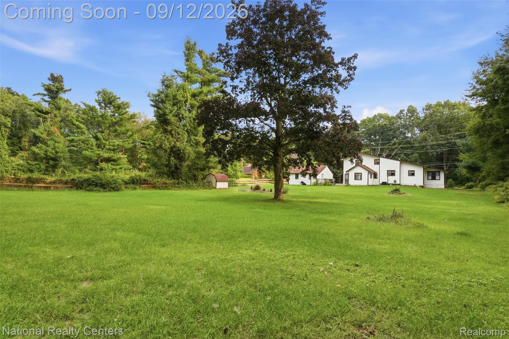 2631 Garden Road Milford, MI 48381 - Photo 31 of 40 Expansive green lawn with mature trees and a detached shed