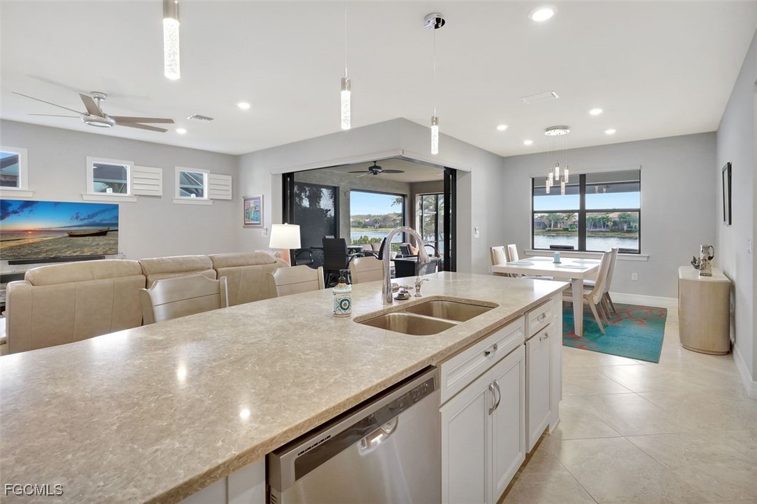 11812 Clifton Terrace Fort Myers, FL 33913 - Photo 12 of 46 a kitchen with stainless steel appliances granite countertop a sink a stove and a large window