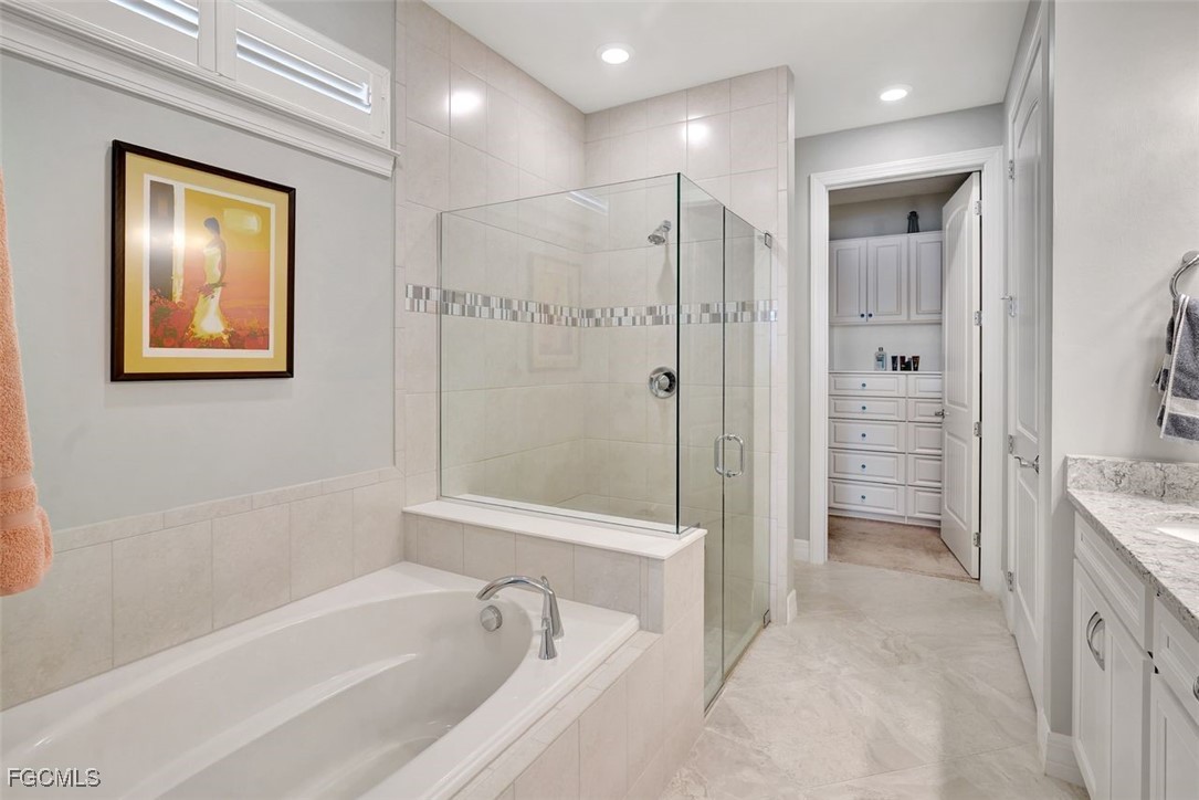 11812 Clifton Terrace Fort Myers, FL 33913 - Photo 24 of 46 a bathroom with a tub a sink and mirrors