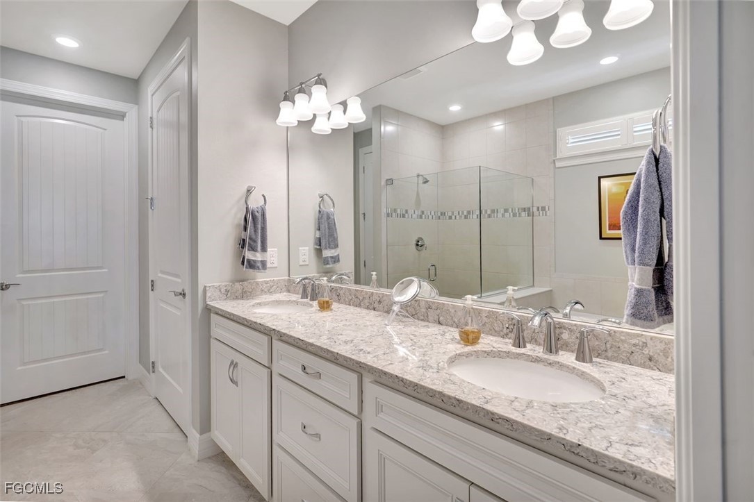11812 Clifton Terrace Fort Myers, FL 33913 - Photo 25 of 46 a bathroom with a granite countertop double vanity sink and a mirror