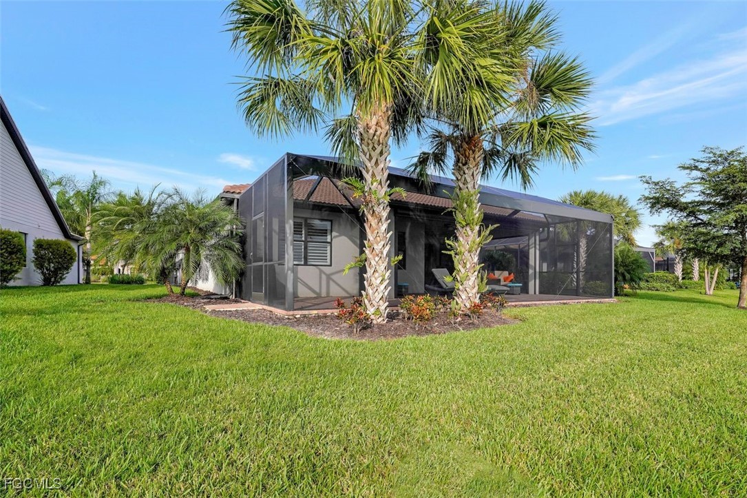 11812 Clifton Terrace Fort Myers, FL 33913 - Photo 35 of 46 a view of a house with a yard and palm trees