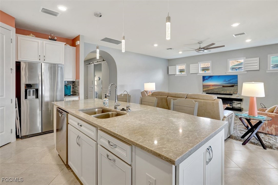 11812 Clifton Terrace Fort Myers, FL 33913 - Photo 10 of 46 a kitchen with stainless steel appliances granite countertop a sink and refrigerator