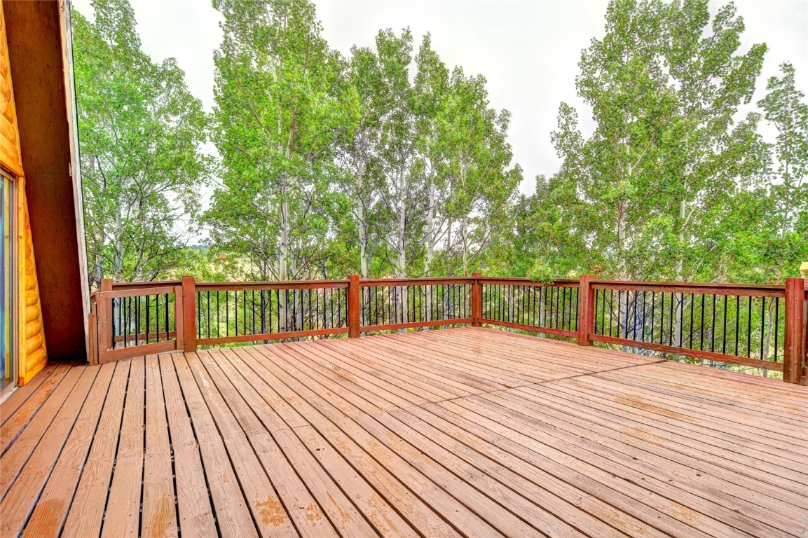 567 Haida Road Como, CO 80456 - Photo 7 of 50 a balcony with wooden floor and trees