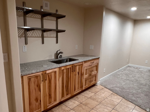 2001 Fielding Hill Lane Draper, UT 84020 - Photo 18 of 21 Kitchen featuring light stone countertops, recessed lighting, light tile patterned floors, light carpet, and wood finish cabinets