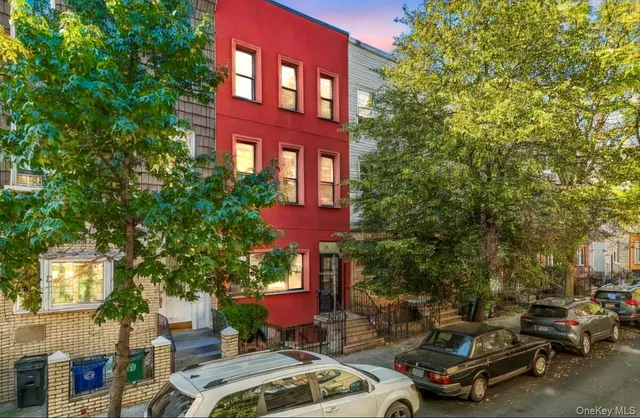 a couple of cars parked in front of a house