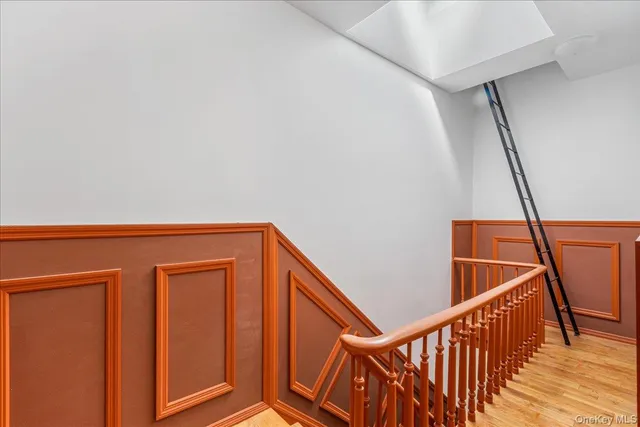 a spacious bedroom with a bed and wooden floor